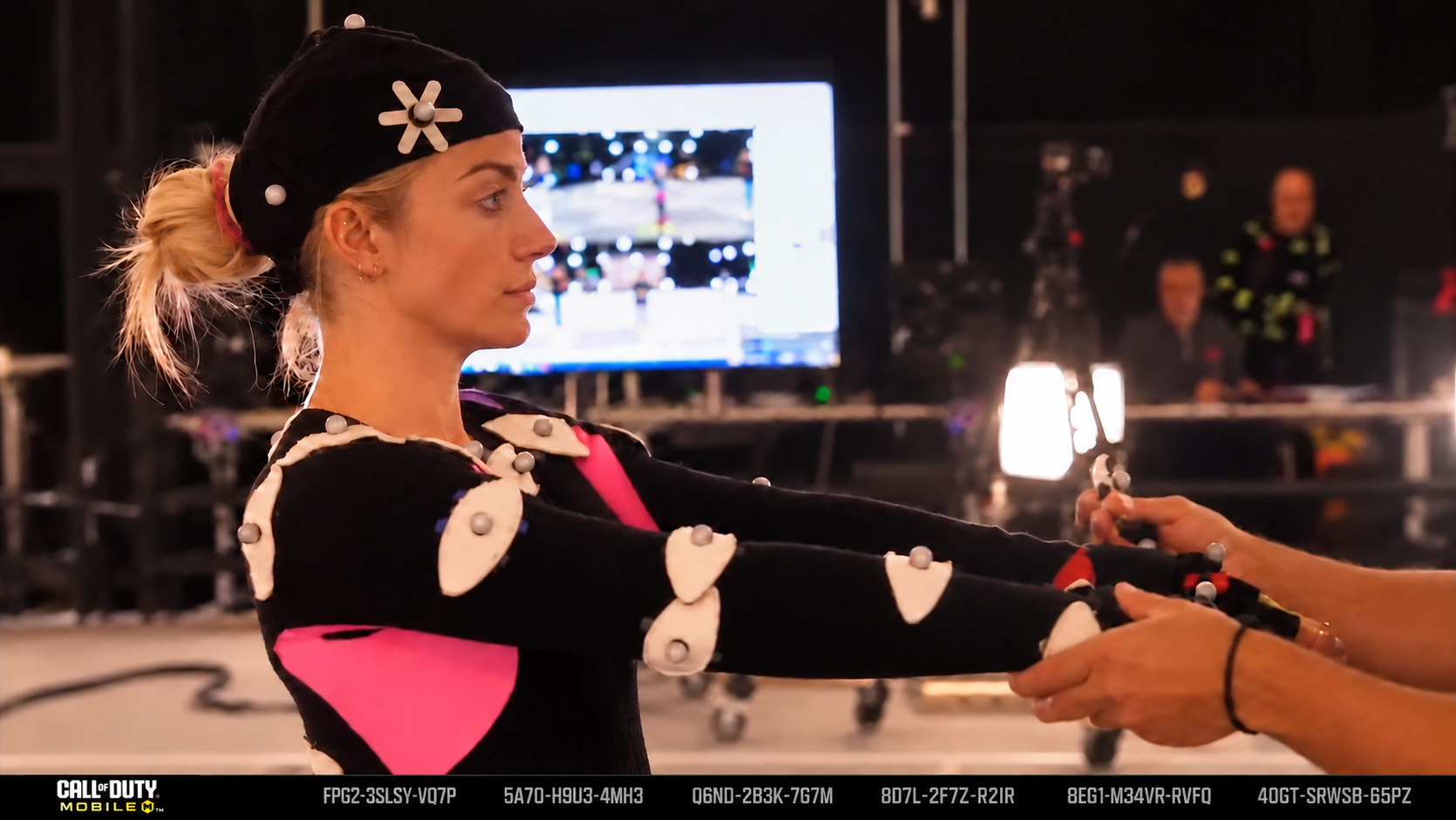 Close-up of a performer in a motion-capture suit and marker beanie mid-take on the capture stage